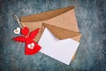 Top view of mock-up blank white greeting christmas card with brown envelope and red angel Royalty Free Stock Photo