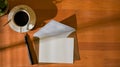 Top view of mock up card with envelope on the table with pen and coffee cup Royalty Free Stock Photo