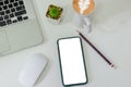 Top view mock up smart phone white blank screen and pencil coffee cup mouse computer laptop flat lay on desk Royalty Free Stock Photo