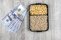 Top view mockup of 100 dollar banknotes and samples of soybean and corn seeds