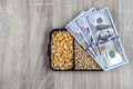 Top view mockup of 100 dollar banknotes and samples of soybean and corn seeds