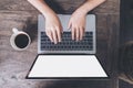 Top view mockup image of business woman using and typing on laptop with blank white screen and coffee cup Royalty Free Stock Photo