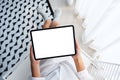 A woman holding black tablet pc with blank white desktop screen while sitting in bedroom with feeling Royalty Free Stock Photo
