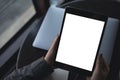 Top view mockup image of woman`s hands holding black tablet pc with blank white desktop screen Royalty Free Stock Photo