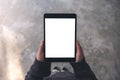 Woman`s hands holding and using black tablet pc with blank white desktop screen while standing outdoors Royalty Free Stock Photo