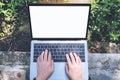 Top view mockup image of a woman using and typing on laptop with blank white desktop screen , sitting at outdoor Royalty Free Stock Photo