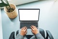 A woman using and typing on laptop computer  with blank white desktop screen in office Royalty Free Stock Photo