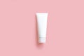 Top view of mockup model of white squeeze bottle cream tube on pink background. Plastic flacon for body lotion, toiletry.