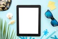 Top view mockup summer work desk. Tablet pc for responsive design with seashell, sunglasses and palm leaf Royalty Free Stock Photo