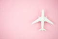 Top view model plane, airplane toy on pink pastel background. Flat lay with copy space for travel banner