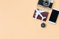 Top view of model plane, passport, compass and mobile phone on orange color background, travel concept. Flat lay , copy space