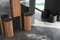 Top view of modern bathroom with black walls and concrete floor, black toilet, double sinks