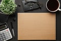Top view of modern black office desk with blank paper sheet, notebook, pen and a lot of things. Flat lay table layout. Copy space Royalty Free Stock Photo
