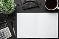 Top view of modern black office desk with blank paper sheet, notebook, pen and a lot of things. Flat lay table layout. Copy space Royalty Free Stock Photo