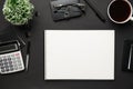 Top view of modern black office desk with blank paper sheet, notebook, pen and a lot of things. Flat lay table layout. Copy space Royalty Free Stock Photo