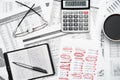 Top view of modern black office desk with notebook, pencil, financial statements and a lot of things. Flat lay table layout Royalty Free Stock Photo