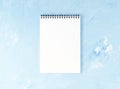 Top view of modern bright blue office desktop with notepad. Mock up, empty space Royalty Free Stock Photo