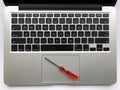 Top view of modern laptop computer with screwdriver on touchpad. Laptop repair concept, teardown Royalty Free Stock Photo