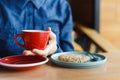 top view of a modern man in a coffee shop holding a red cup Royalty Free Stock Photo