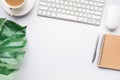 Top view modern office desk table with tropical leaves