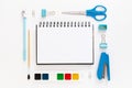 Top view of modern white blue office desktop with school supplies and stationery on table around empty space for text. Back to Royalty Free Stock Photo