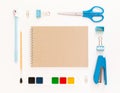 Top view of modern white blue office desktop with school supplies and stationery on table around empty space for text. Back to Royalty Free Stock Photo