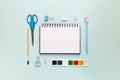 Top view of modern white blue office desktop with school supplies and stationery on table around empty space for text. Back to Royalty Free Stock Photo