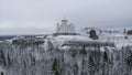 Top view of monastery on mountain with winter forest. Clip. Winter landscape of church on hill with wild forest. Snowy Royalty Free Stock Photo