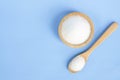 Top view monosodium glutamate in wood bowl and spoon on light bl Royalty Free Stock Photo