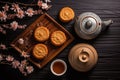 Top view of a moon cakes cookies, tea pot and tea cup on a bamboo mat Royalty Free Stock Photo