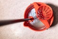 top view of mop rinsing in red bucket with water Royalty Free Stock Photo