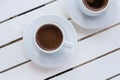 Top view of the morning coffee in white cup on light wooden table. Lifestyle background Royalty Free Stock Photo