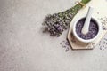 Top view of mortar and pestle with lavender flowers on stone background, space for text. Natural cosmetic