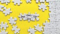 Top view of motivational quote on yellow cover - Just do not give up with jigsaw puzzle missing pieces background. Royalty Free Stock Photo