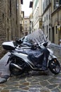 Florence, Italy - August 30 2023: Motorcycles and motor scooters parked in a row on a sidewalk. Royalty Free Stock Photo