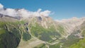 Top view of mountain range with rocks and low clouds in summer. Clip. Majestic mountains with rich greenery and Royalty Free Stock Photo