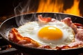Top view of a mouthwatering fried egg sizzling with perfectly cooked bacon in a skillet