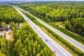 Top view of movement of cars on the motorway through the forest