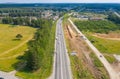 Top view of the movement of cars on the motorway through the forest