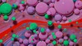 Top view movement of red oil ink drops bubbles, multicolored artistic paint surface background