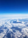 Top view - Mt Fuji from sky view on window seat of plane. Blue sky and many clouds Royalty Free Stock Photo