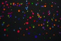 Top view on the multi-colored colorful rhinestones scattered on a black background. Abstraction Royalty Free Stock Photo