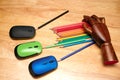 Top view of multi-colored pencils, computer mouses with an articulated wooden hand