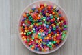 Top view of multi-colored plastic beads on plastic container in a table Royalty Free Stock Photo