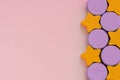 Top view on multicolored kids toys on light pink paper background. Wooden orange stars, lilac circles on right side. Copy space Royalty Free Stock Photo