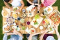 Top view on multicultural group of friends eating grilled food d