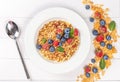 Top view, multigrain breakfast on wooden white background with strawberries, blueberries and mint leaves