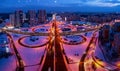 Top view, multilevel transport interchange in the evening city.