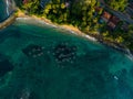 Top view of multiple oruwa outrigged canoe boats fishing in clear turquoise waters near a tropical shoreline, surrounded Royalty Free Stock Photo