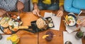 Top view of multiracial friends having healthy lunch in coffee brunch bar Royalty Free Stock Photo